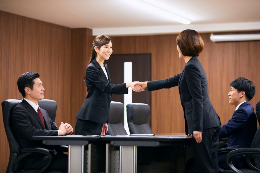 invoice finance team shaking hands after discussion
